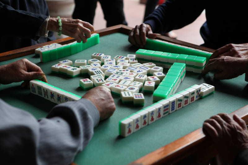 O mahjong na mesa antigo jogo de tabuleiro asiático fecha a